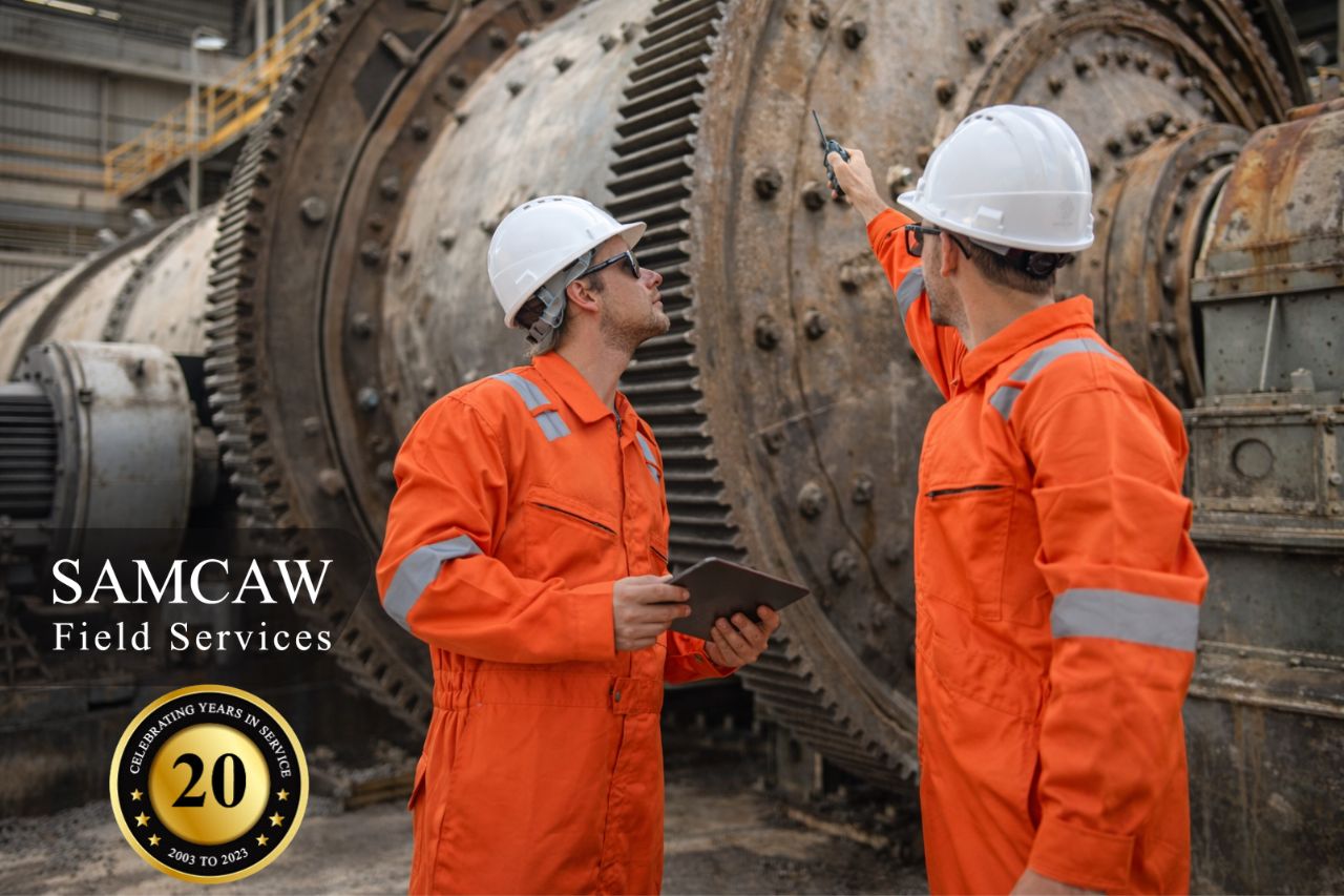 Technicians inspecting grinding mill components before a scheduled shutdown in a South African processing plant.